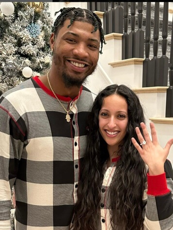 Marcus Smart with her fiancee.